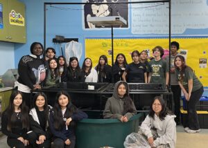 Harmony Aquaponic System With Students standing around the system