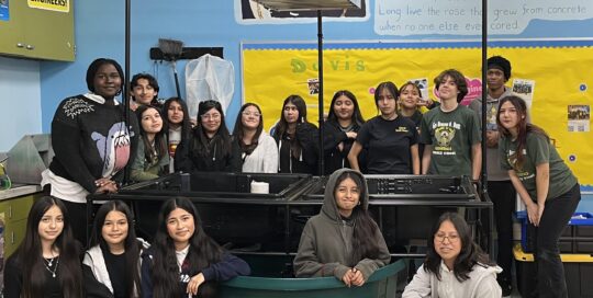 Harmony Aquaponic System With Students standing around the system